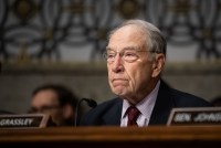 A photograph of Sen. Chuck Grassley, who is seated during a senate hearing.