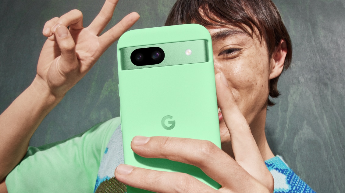 Person talking a selfie with Pixel 8a in Aloe color.