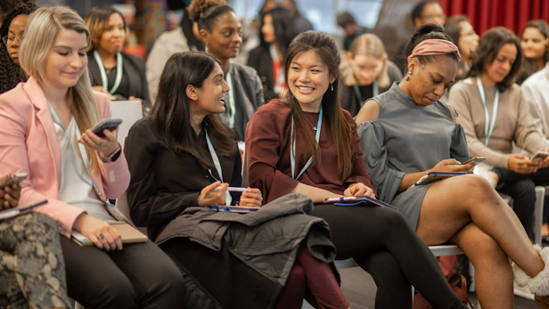 A crowd of enthusiastic attendees at a Women @ Google event