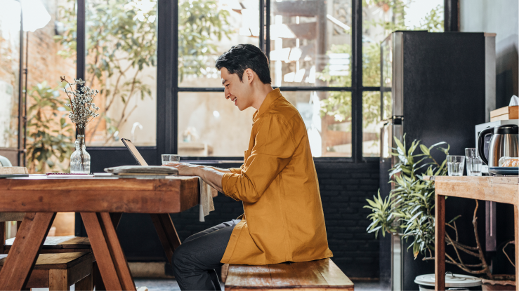 Person sitting at desk working on laptop 