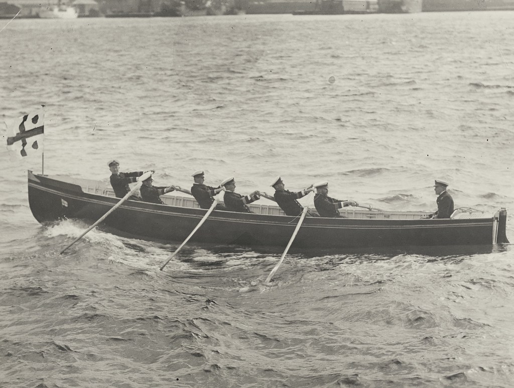 New Zealand naval personnel rowing a boat across a harbour, 194-?