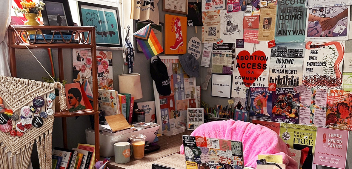 A room covered in posters, stickers and other paraphernalia