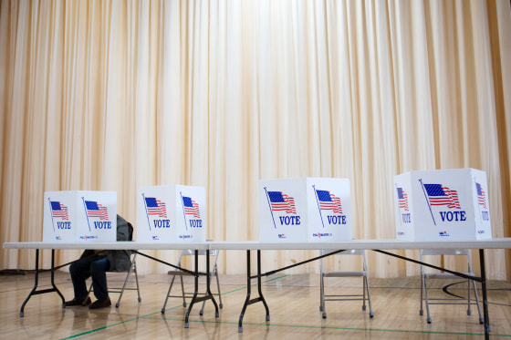 A voter casts his ballot in the New Hampshire primary in Laconia on Jan. 22.