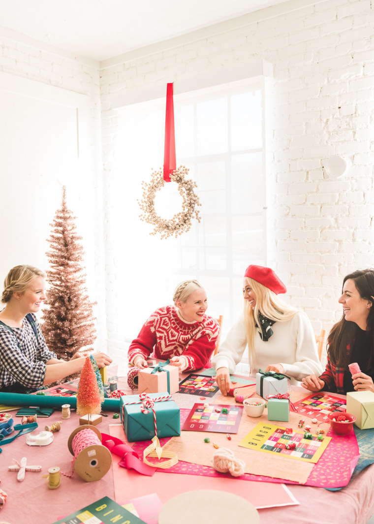 group of girls wrapping christmas gifts