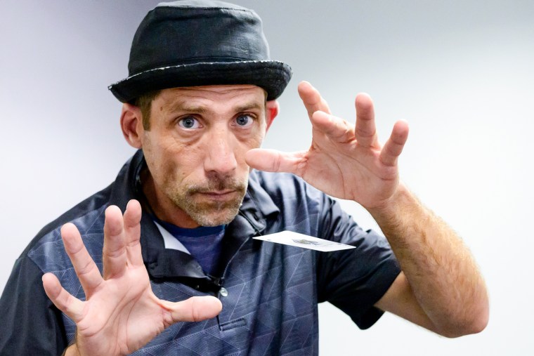 Paul Carpenter, a New Orleans magician, performs card tricks during an interview in New Orleans on Friday.