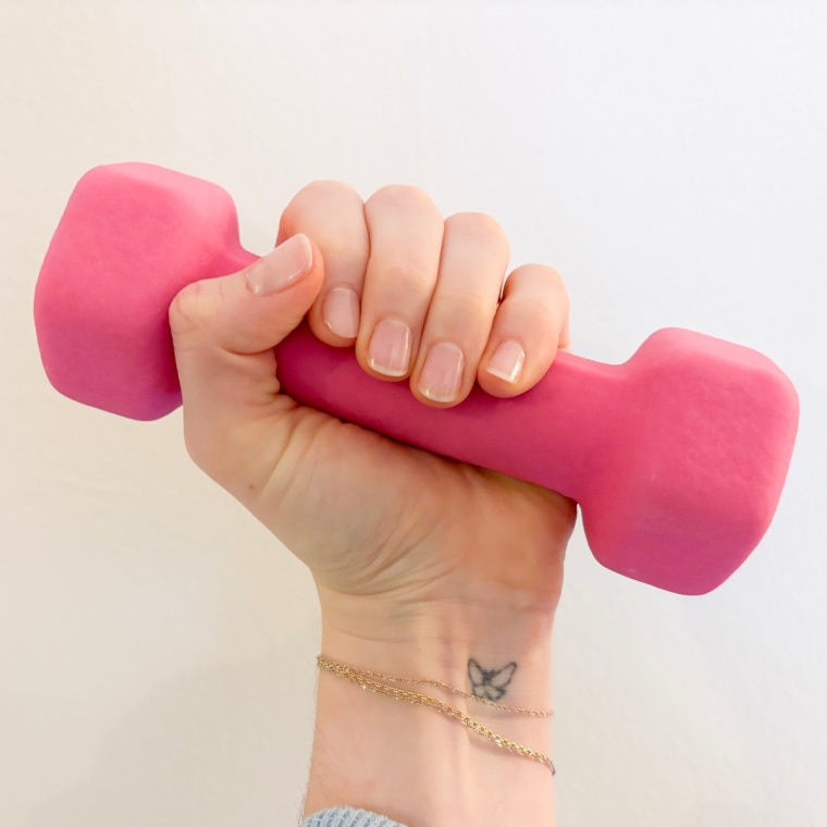 Woman holding pink 3-pound dumbbell