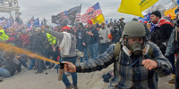 Trump supporters, including the "blueplaidsprayer," clash with police at the Capitol on Jan. 6, 2021.