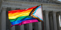 A person waves LGBTQ flag.