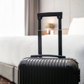 A suitcase in hotel room.