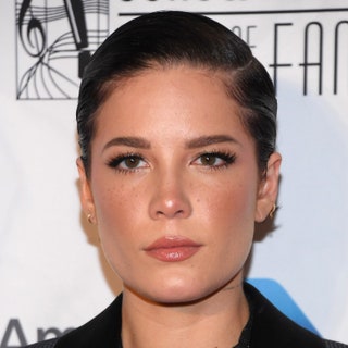 Photo of Halsey with short slickeddown hair and a deep side part