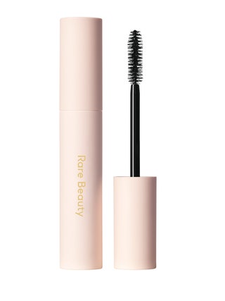 An open tube of Rare Beauty Perfect Strokes Universal Volumizing Mascara on white background