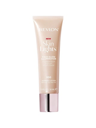 Revlon SkinLights Face Glow Illuminator tube of pale beige liquid highlighter with shiny pink cap on white background