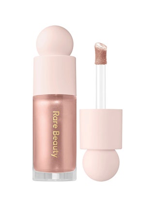 Rare Beauty Light Liquid Luminizer Highlight rose gold liquid highlighter tube with rounded pale pink topper and doe...