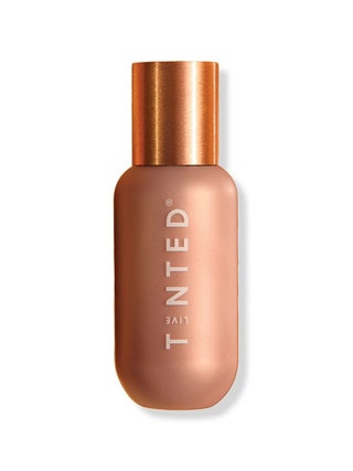 Live Tinted Hueglow bronze bottle of liquid highlighter with orangey bronze cap on white background