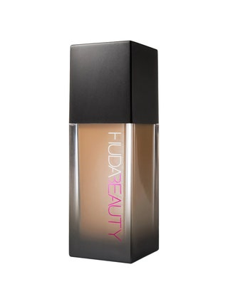 Huda Beauty FauxFilter Foundation rectangular translucent to black gradient bottle of foundation with black cap on white...