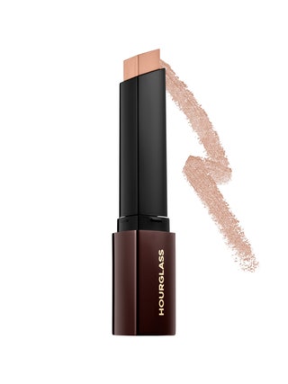 Hourglass Vanish Seamless Foundation Stick brown and black tube of foundation stick with triangular tip with swatch on...