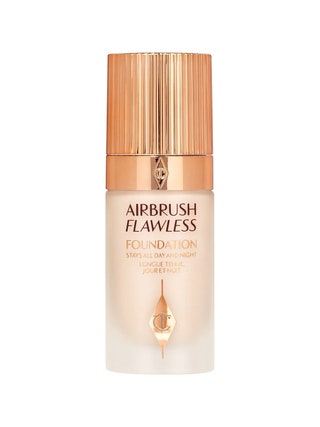 Charlotte Tilbury Airbrush Flawless Longwear Foundation cloudy transparent bottle of foundation with gold cap on white...