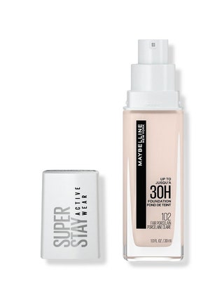 Maybelline Super Stay Full Coverage Liquid Foundation transparent bottle of foundation with white pump top and cap on...