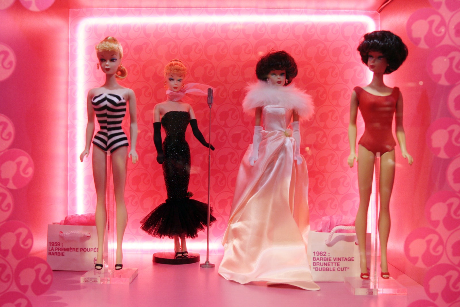 Vintage barbie dolls on display at an exhibition.