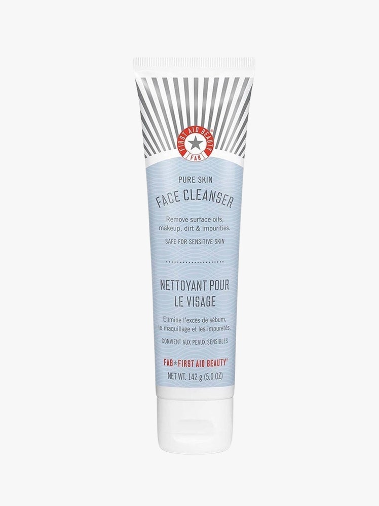 First Aid Beauty Pure Skin Face Cleanser blue tube with white top on light grey background