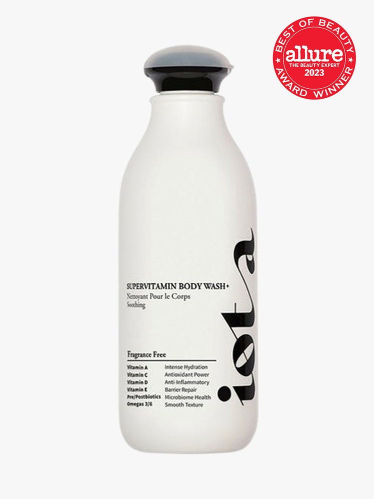 Iota Supervitamin Body Wash+, Soothing white bottle with black top on light grey background