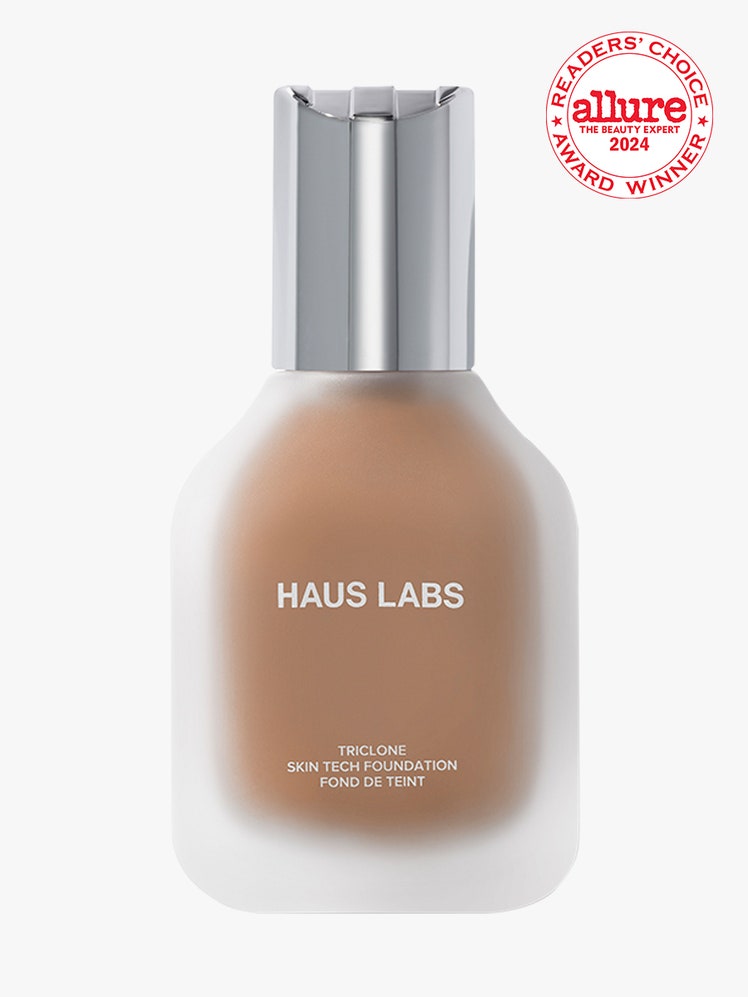 Haus Labs Triclone Skin Tech Medium Coverage Foundation cloudy bottle of foundation with silver cap on light gray background with white and red Allure Readers' Choice Awards seal in the top right corner