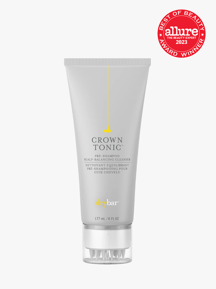 Drybar Crown Tonic Pre-Shampoo Scalp-Balancing Cleanser in branded gray tube with special applicator cap on light gray background