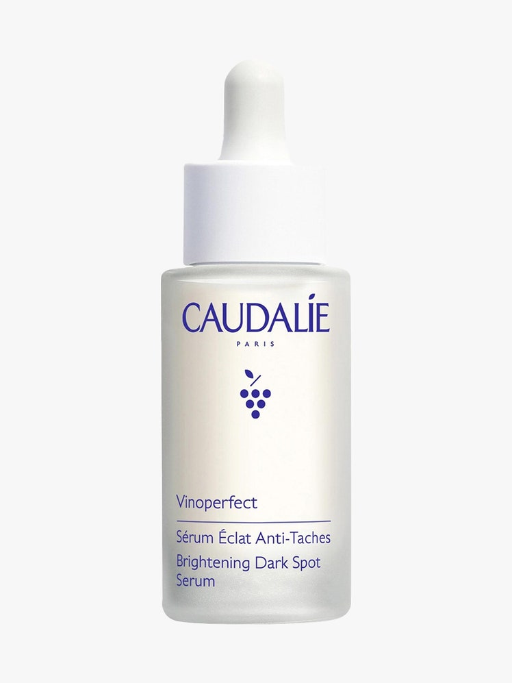 Caudalie Vinoperfect Radiance Serum white serum bottle on light gray background