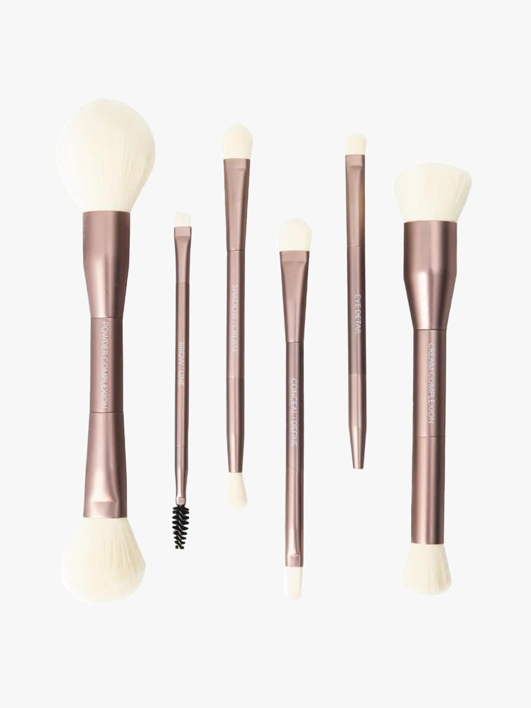 Jenny Patinkin Dual-Ended Sustainable Luxury Makeup Brush Set with six different brushes with muted copper handles with white bristles on light gray background