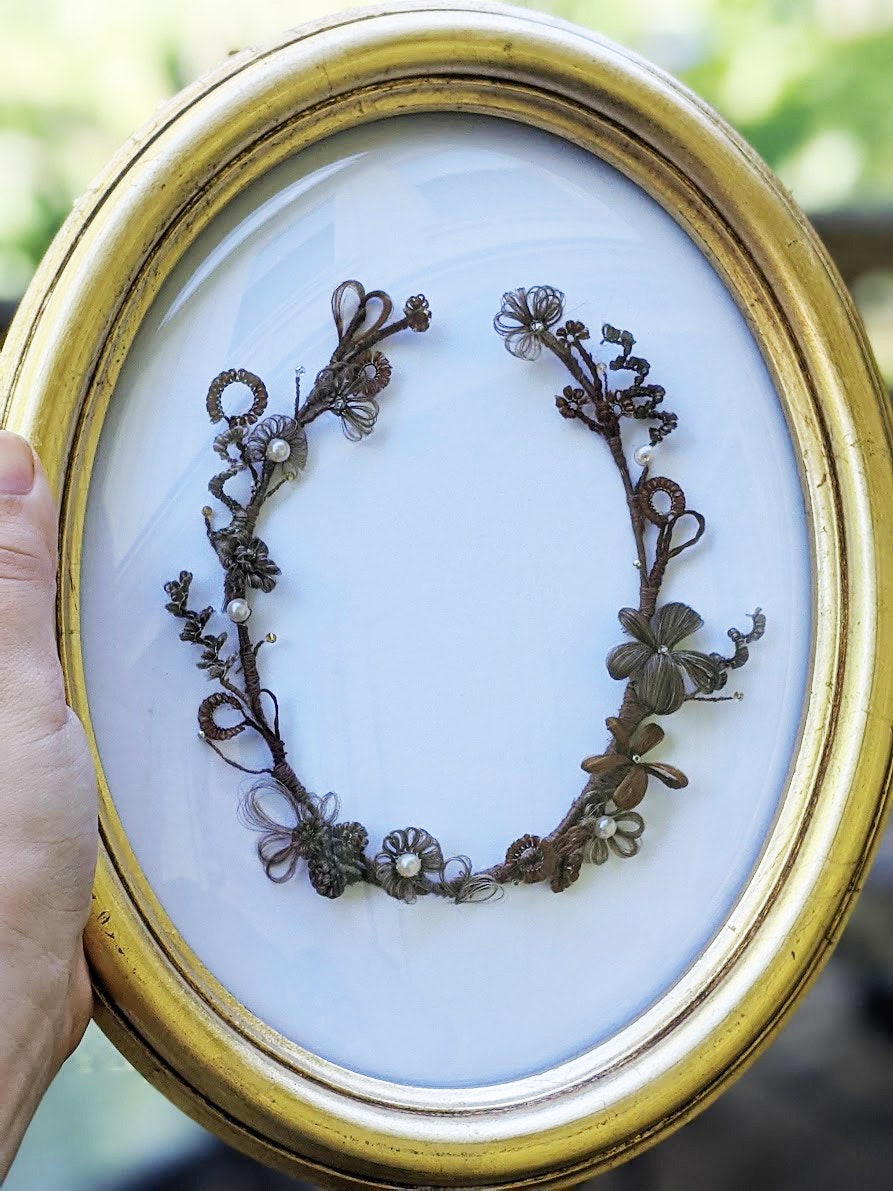 a hairwork floral wreath made by courtney lane