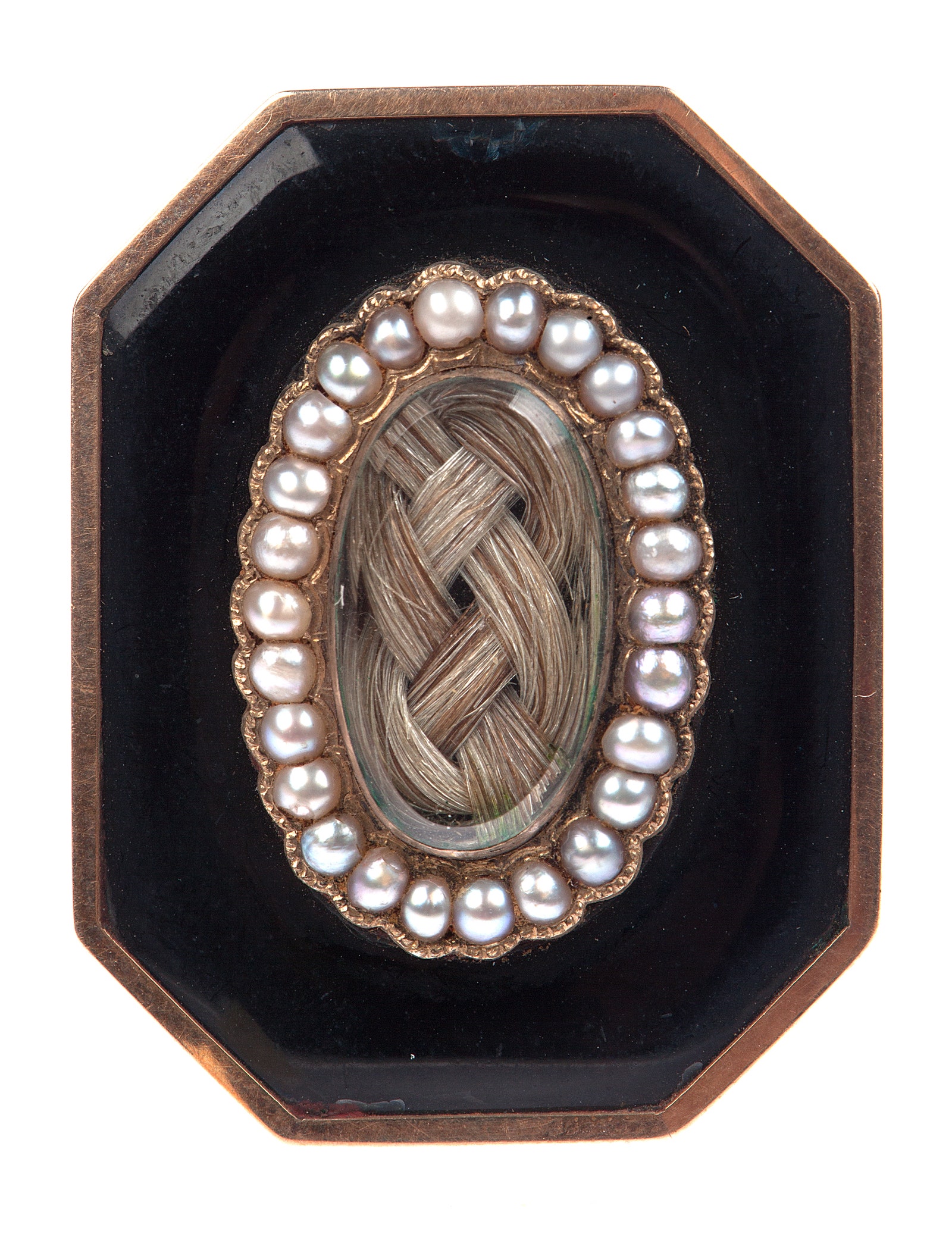 a black mourning brooch with encapsulated braided hair surrounded by pearls circa 1860