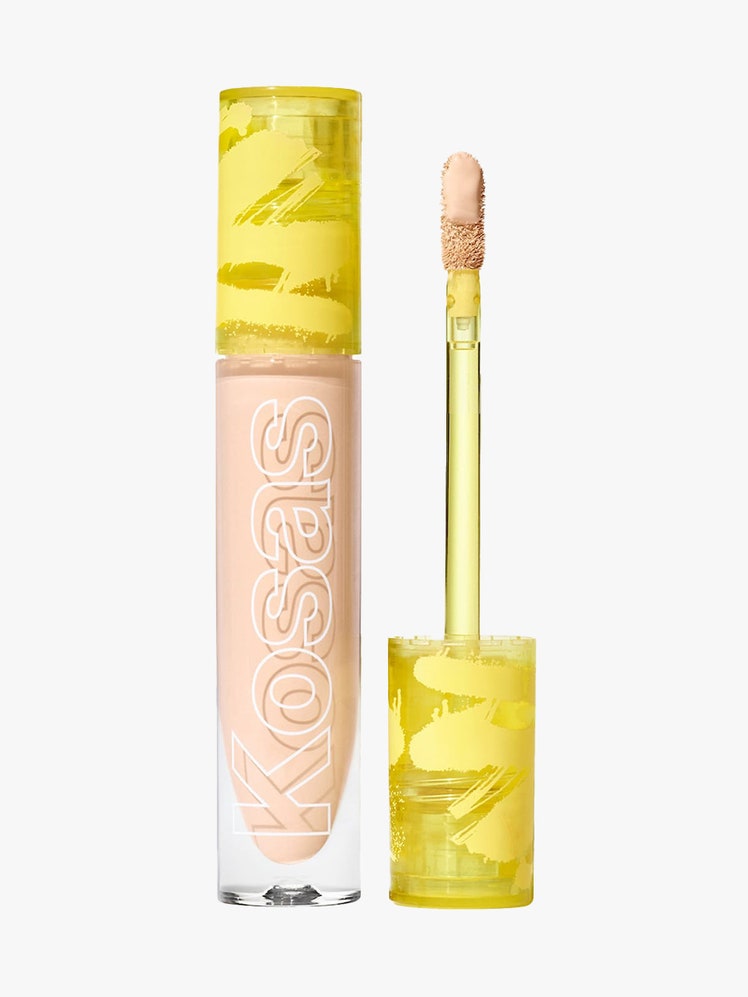 Kosas Revealer Concealer vial of concealer with neon yellow cap and wand to the side on light gray background
