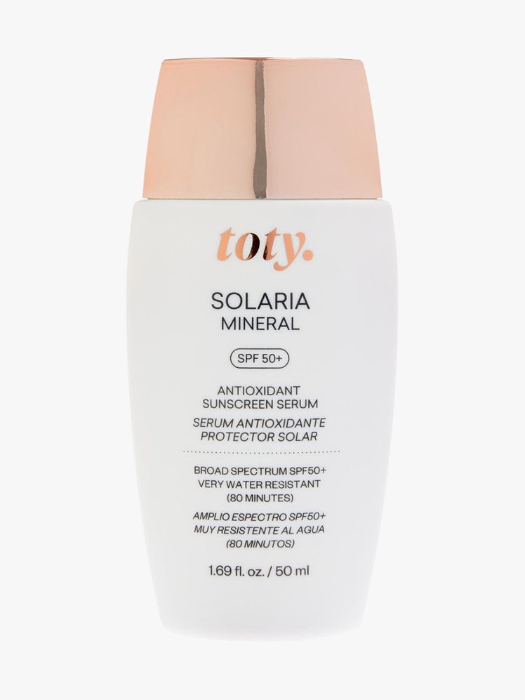 Toty Solaria Mineral SPF 50+ white curved bottle with rose gold cap on light gray background