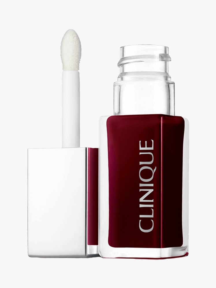 Clinique Pop Lip + Cheek Oil in Black Honey vial of burgundy lip oil with silver cap and wand to the side on light gray background