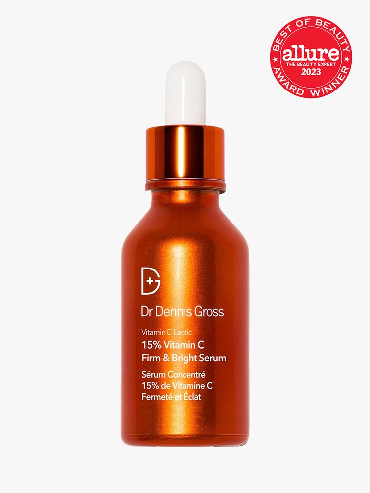 Dr. Dennis Gross Skincare Vitamin C Lactic 15% Firm & Bright Serum orange dropper with red best of beauty seal on light grey background