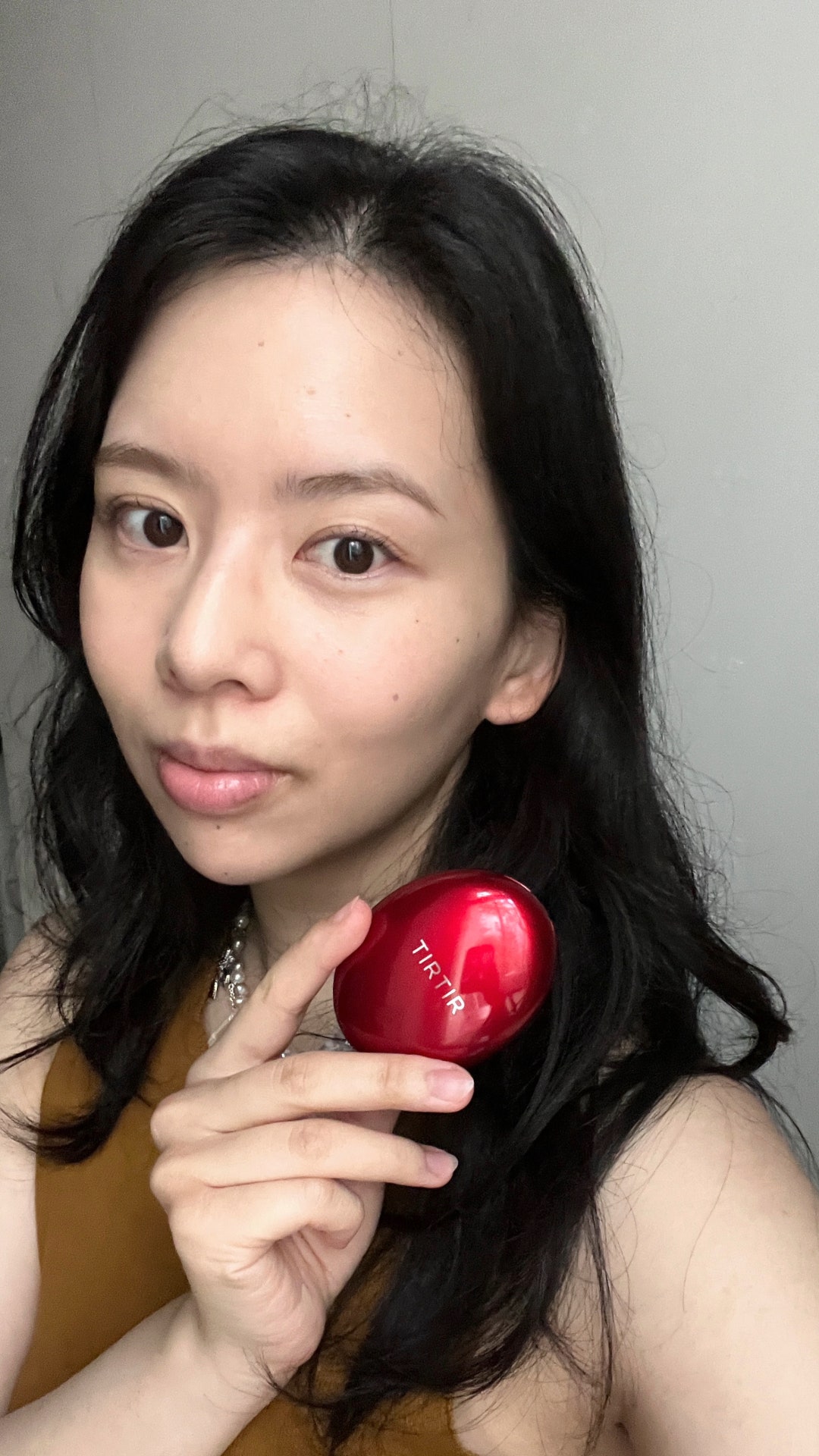 A selfie of Allure contributor Sarah Y. Wu after applying Tirtir Mask Fit Red Cushion Foundation