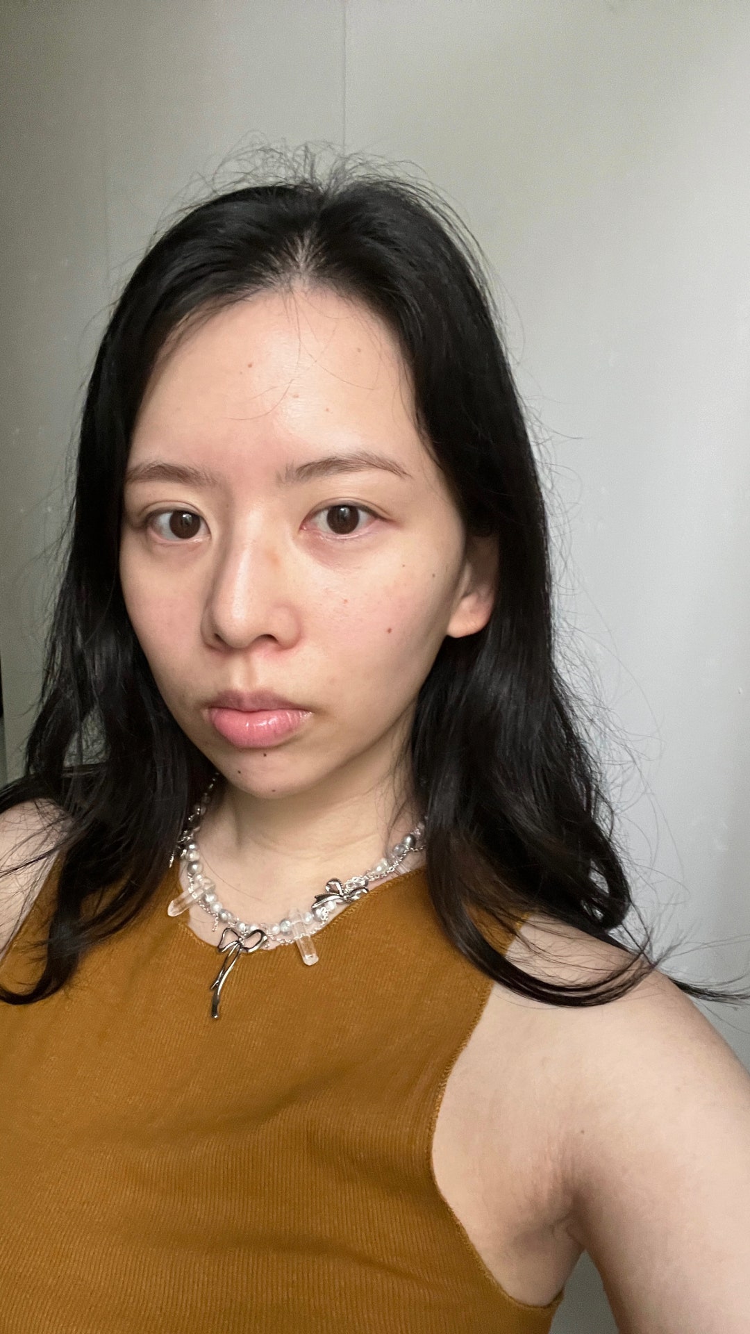 A selfie of Allure contributor Sarah Y. Wu with no foundation