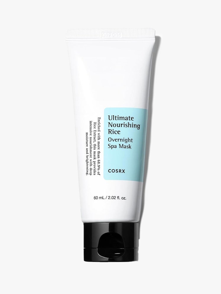 Cosrx Ultimate Nourishing Rice Overnight Spa Mask in white bottle with black cap on gray background