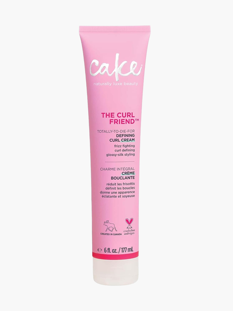 The Curl Friend Defining Curl Cream in branded pink tube with clear cap on light gray background