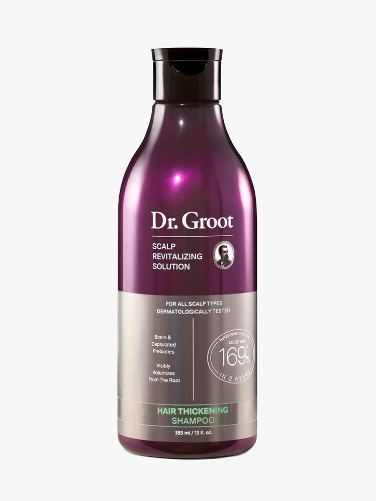 Hair Thickening Shampoo in purple bottle on gray background