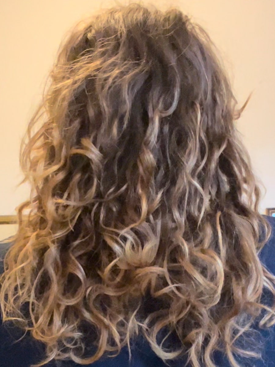 girl with curly hair facing away from the camera