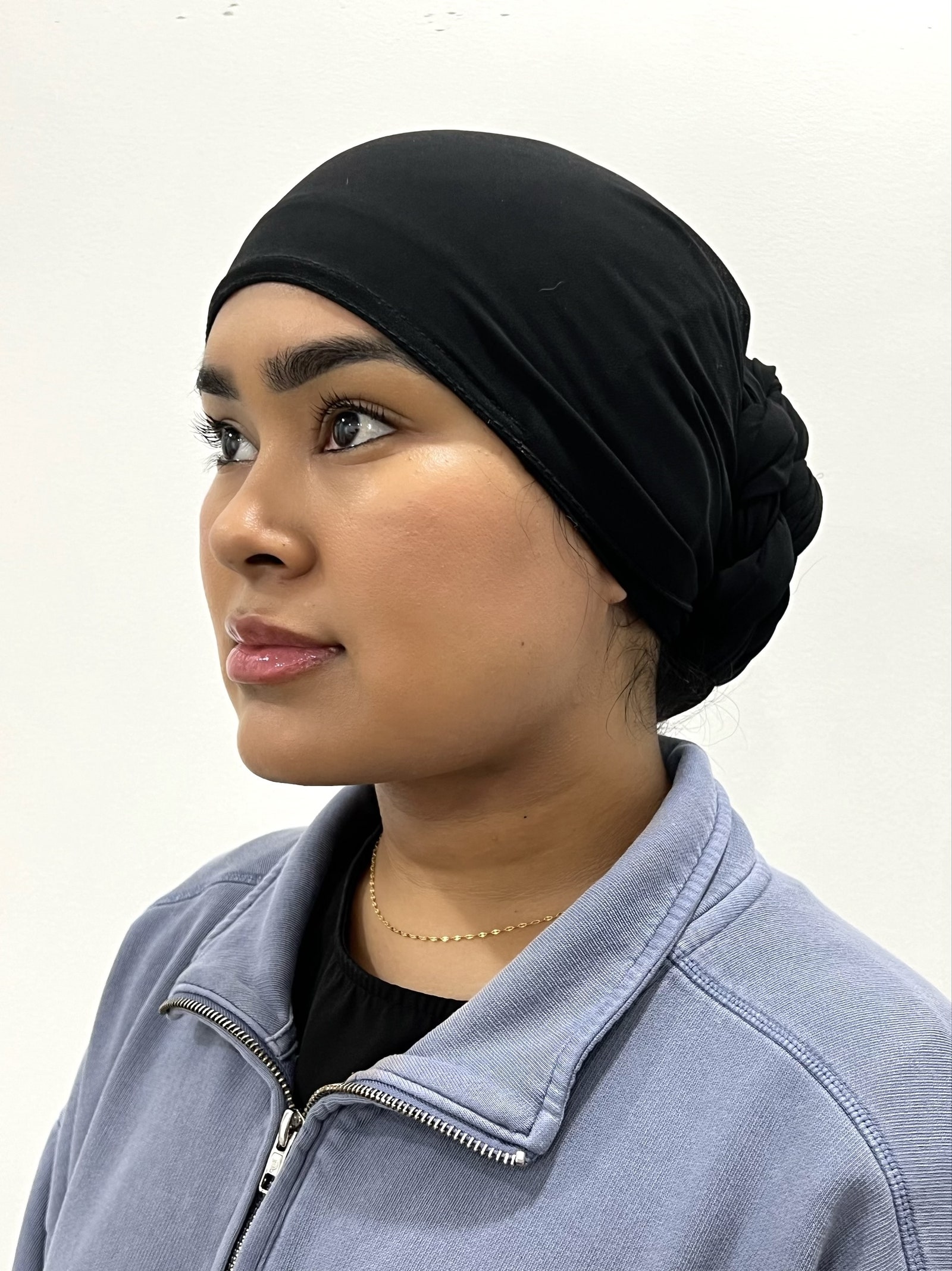 A women after jawline liposuction. She is shown from the side against a white background