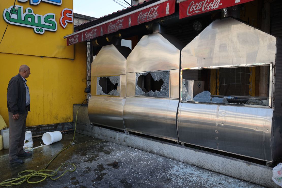 A man inspects the damage to a restaurant following a reported attack by Israeli settlers in Huwara on March 28.