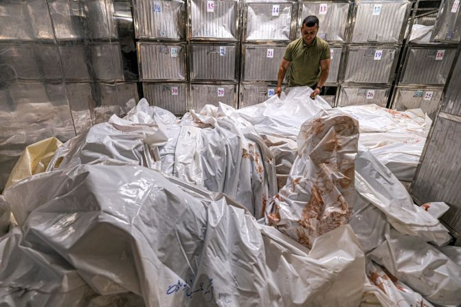 A morgue worker arranges body bags at al-Shifa hospital in Gaza City on October 12.