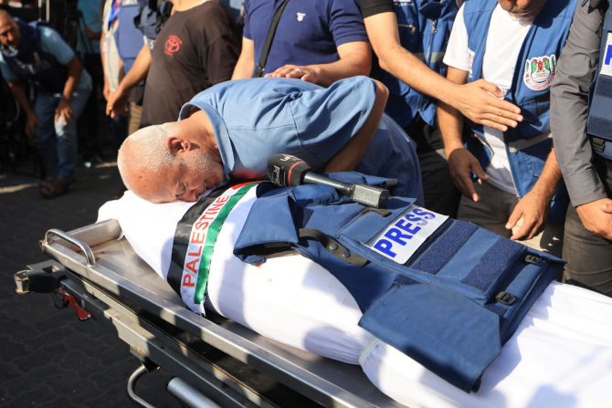 A relative bids farewell during the funerals of Palestine TV journalist Mohammad Abu Hattab and his eleven family members the day after they were killed in Khan Younis, Gaza on November 3.