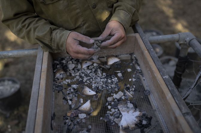 On November 9, an IDF soldier from the Israeli Military Rabbinate looks for items that may help identify people killed at Kibbutz Nir Oz, Israel, in the October 7 attacks.