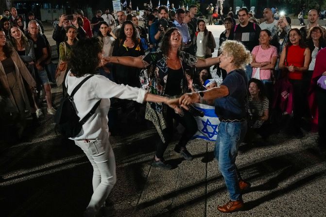 People in Tel Aviv, Israel, react as they hear the news of the release of 13 Israeli hostages held by Hamas on November 24.