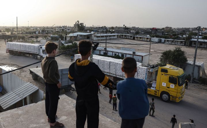 Young boys look at aid trucks entering Gaza on November 26.