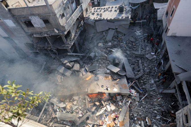 Palestinians inspect a house destroyed in an Israeli strike in Khan Younis, southern Gaza, on December 4.