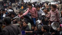 Palestinians line up for a free meal in Rafah, Gaza Strip, Thursday, December 21, 2023.